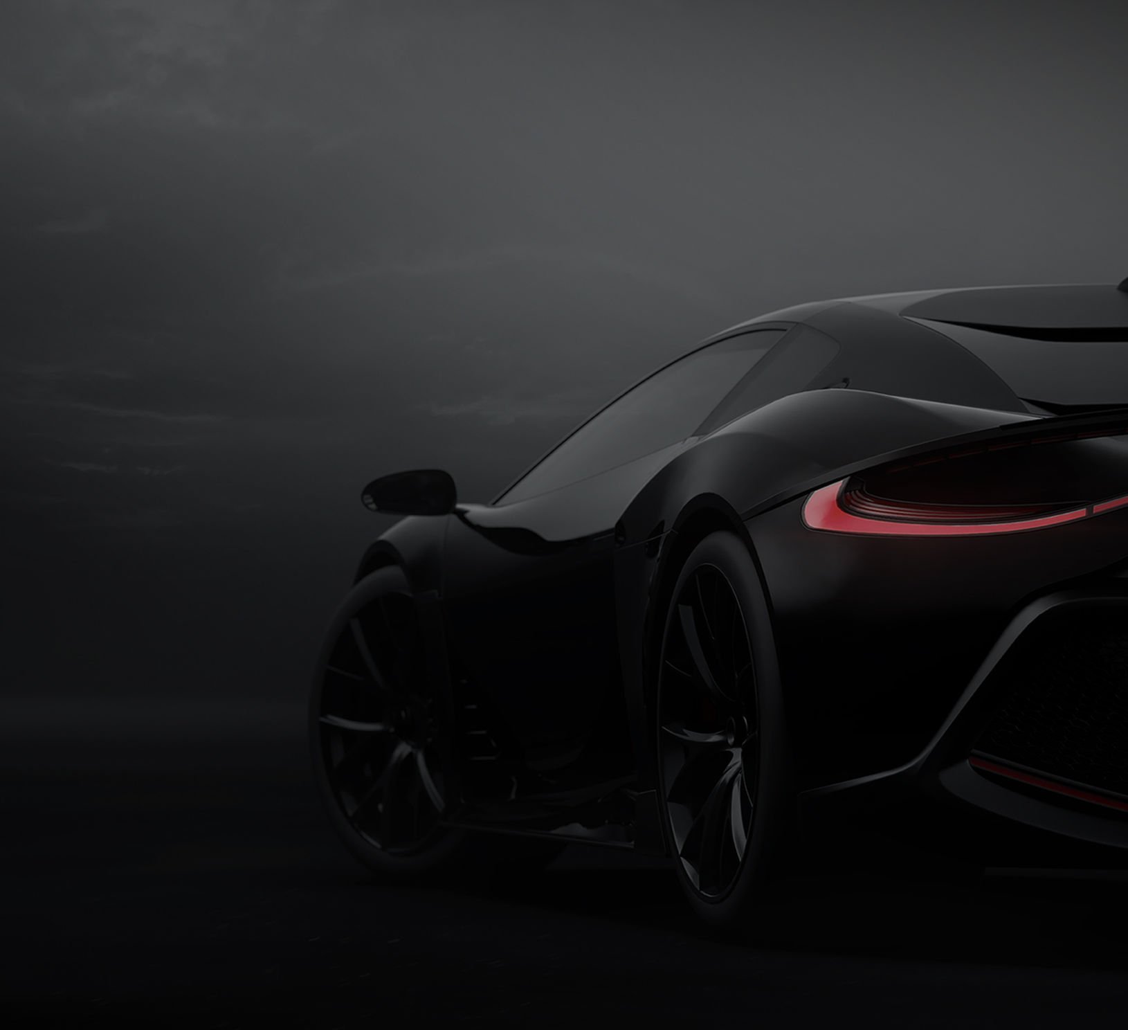 Sleek black sports car silhouette with glowing red taillight against dark background