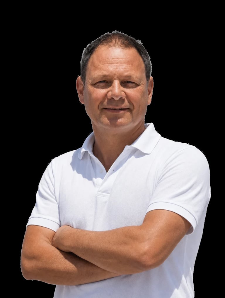 Middle-aged man with crossed arms wearing a white polo shirt, smiling at the camera against a black background